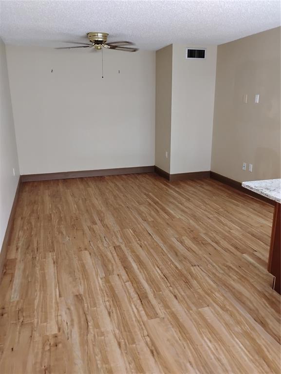 11721 Raintree Drive Tampa, FL 33617 - Photo 5 of 12 wooden floor in an empty room