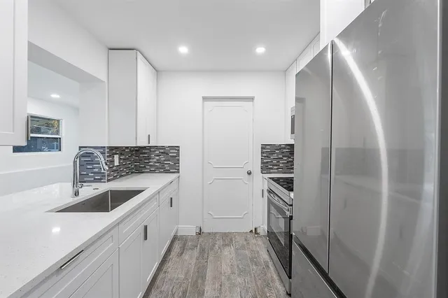 a kitchen with a sink and refrigerator
