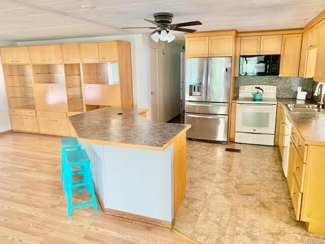 808 South Silver Circle Key Largo, FL 33037 - Photo 8 of 50 a kitchen with stainless steel appliances granite countertop a sink and a refrigerator