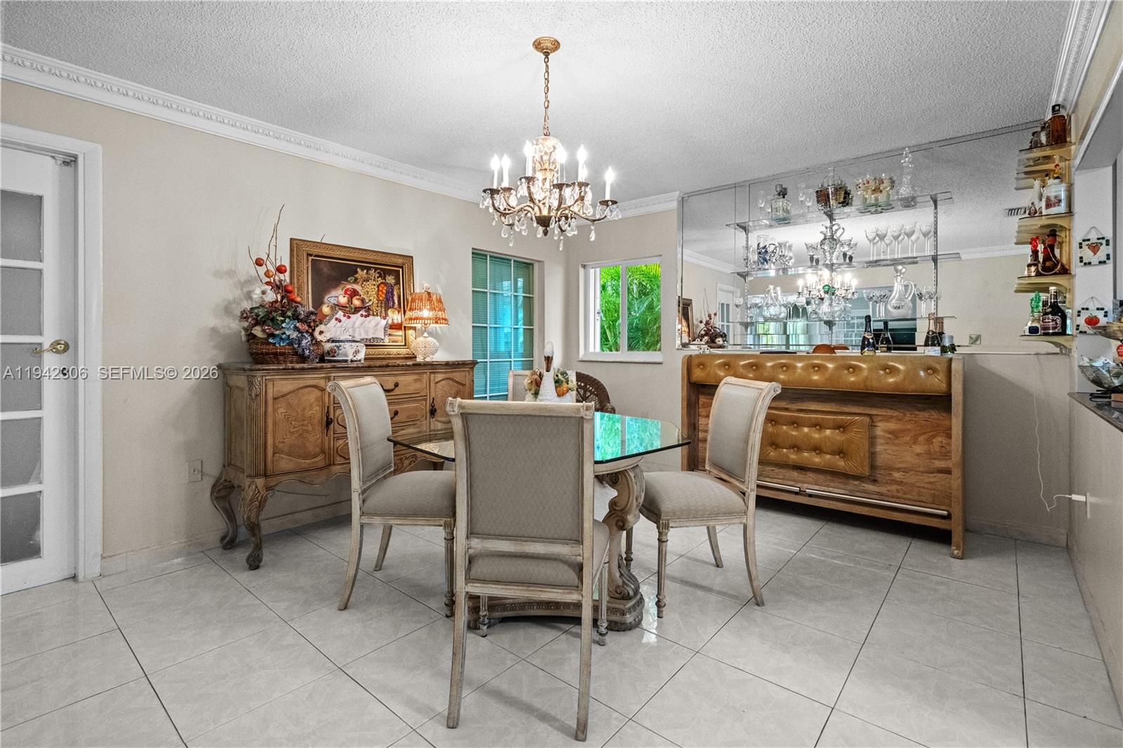 13220 Southwest 5th Street Miami, FL 33184 - Photo 13 of 35 a dining room with furniture and a chandelier