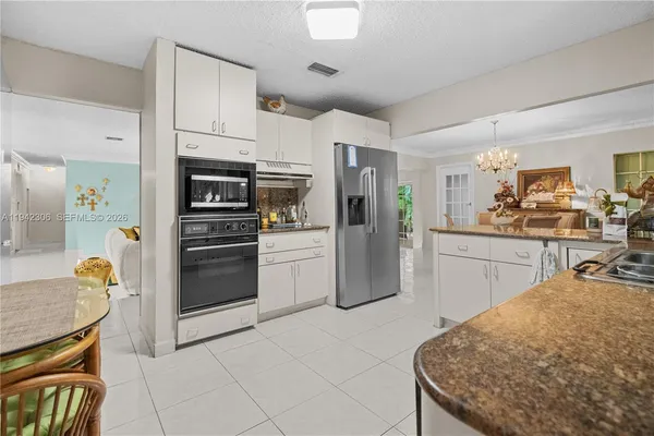 a kitchen with refrigerator cabinets and wooden floor