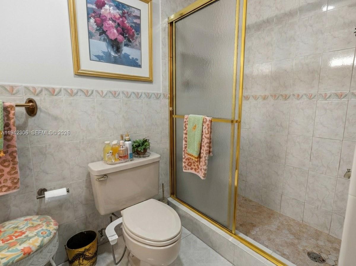 13220 Southwest 5th Street Miami, FL 33184 - Photo 25 of 35 a white toilet sitting next to a bathroom sink