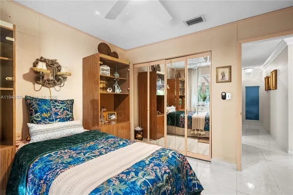 a bedroom with a large bed and a large mirror