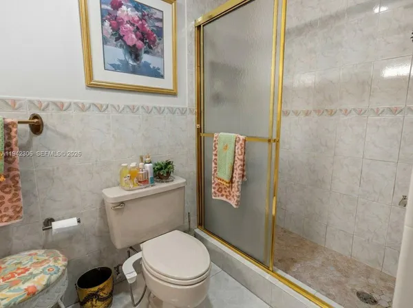 a white toilet sitting next to a bathroom sink