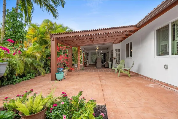 a view of a patio with table and chairs and potted plants