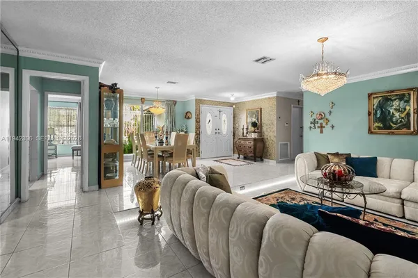 a living room with furniture and a chandelier