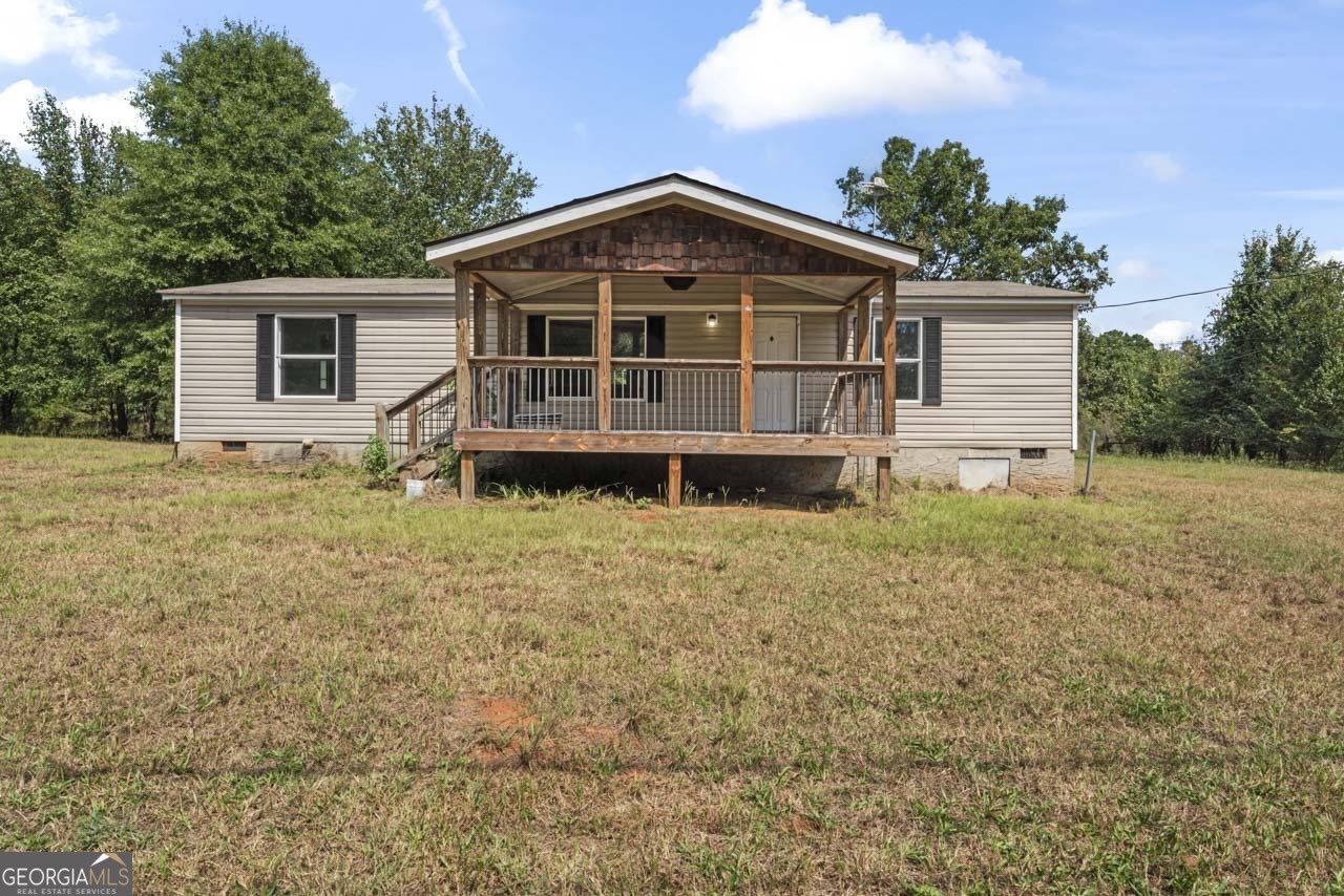 2385 Leguin Mill Road Locust Grove, GA 30248 - Photo 1 of 1 a front view of a house with a yard