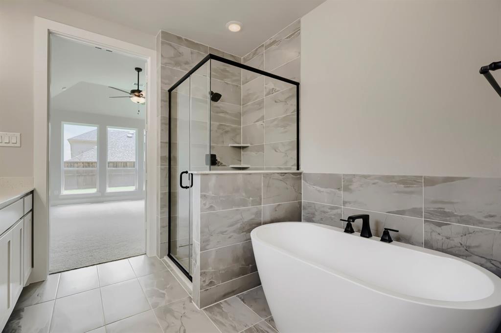 4414 Windy Point Road Oak Point, TX 75068 - Photo 15 of 27 a bathroom with a toilet a sink and bathtub