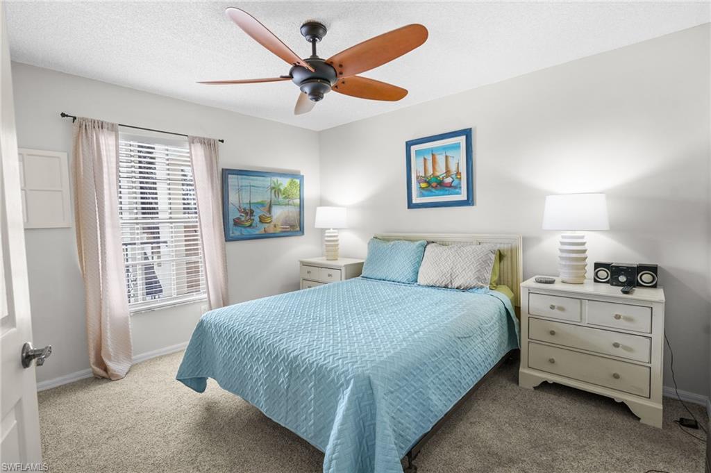 601 Augusta Boulevard, Unit 10 Naples, FL 34113 - Photo 14 of 27 Carpeted bedroom featuring ceiling fan and a textured ceiling