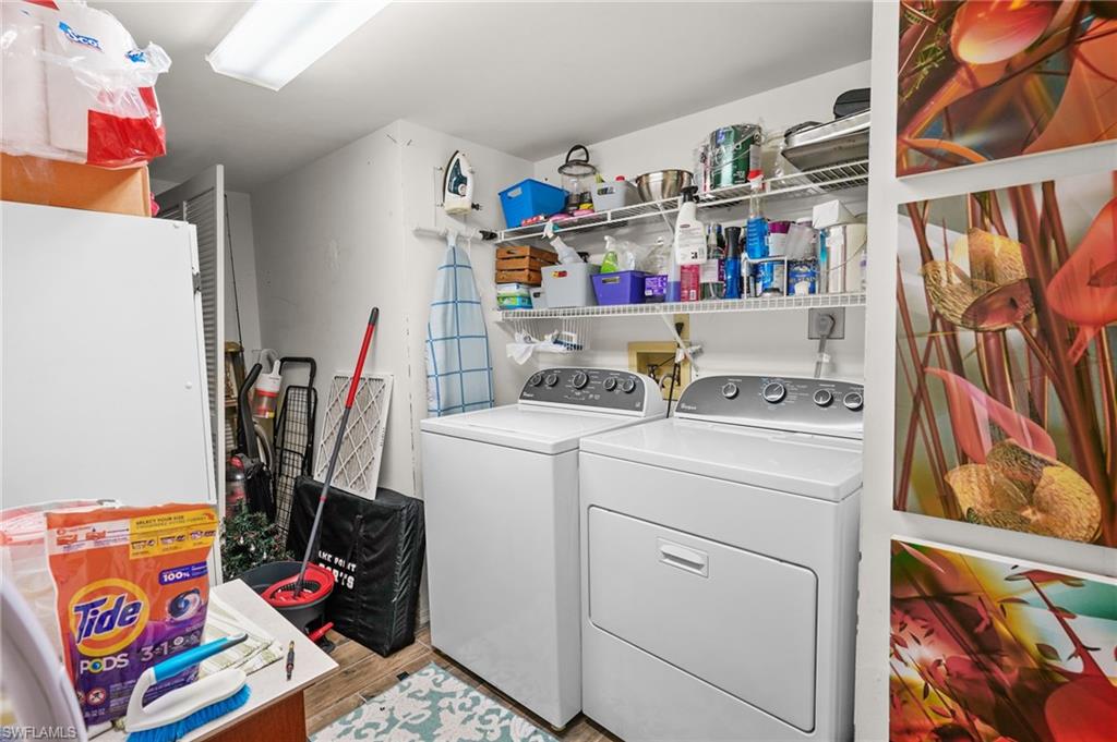 601 Augusta Boulevard, Unit 10 Naples, FL 34113 - Photo 18 of 27 Laundry area featuring washer and dryer and light wood-style flooring
