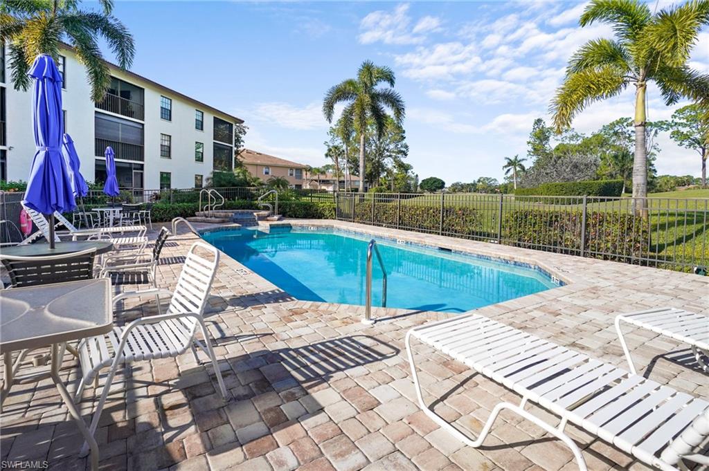 601 Augusta Boulevard, Unit 10 Naples, FL 34113 - Photo 20 of 27 Community pool with a patio