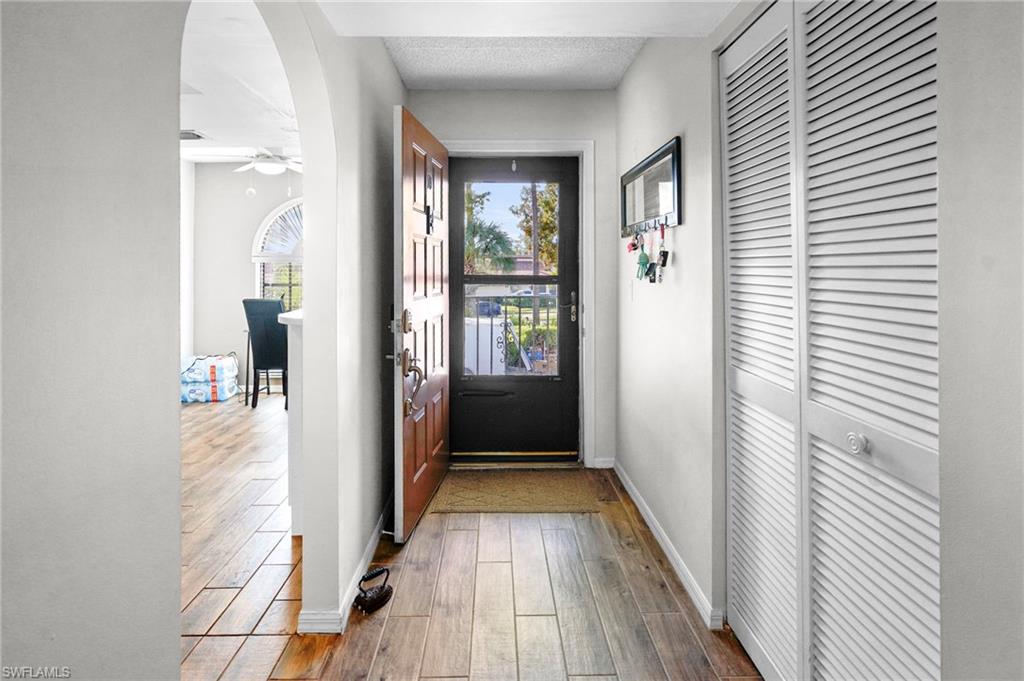 601 Augusta Boulevard, Unit 10 Naples, FL 34113 - Photo 26 of 27 Entryway with wood finished floors, arched walkways, and a ceiling fan