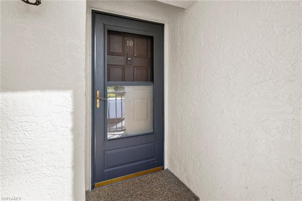 601 Augusta Boulevard, Unit 10 Naples, FL 34113 - Photo 27 of 27 Property entrance with stucco siding