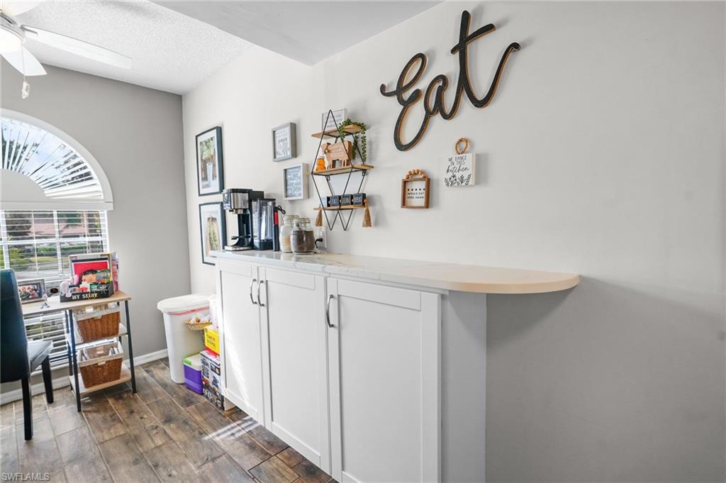601 Augusta Boulevard, Unit 10 Naples, FL 34113 - Photo 10 of 27 Home office with dark wood-style floors and a textured ceiling