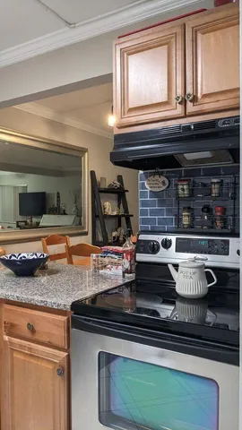 a kitchen with stainless steel appliances granite countertop a sink and a white cabinets