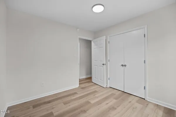a view of an empty room and wooden floor