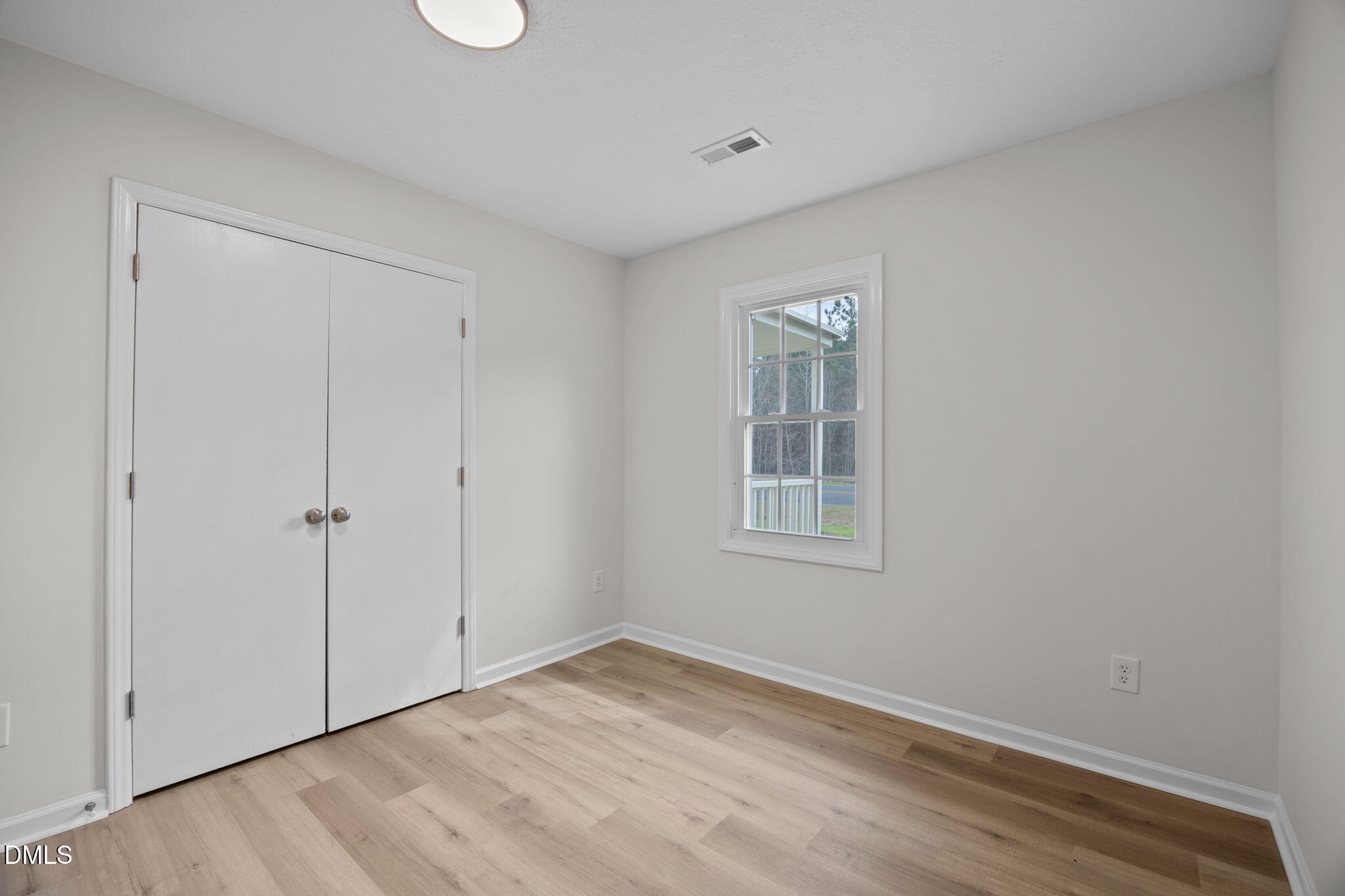 3285 Free Union Church Road Pinetown, NC 27865 - Photo 18 of 41 a view of an empty room with wooden floor and a window