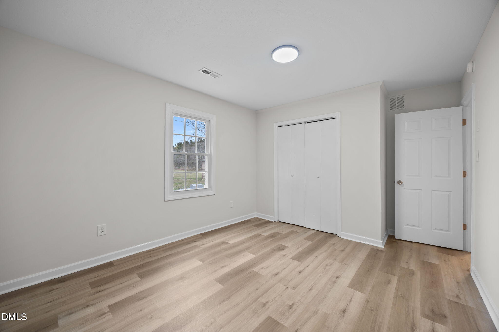 3285 Free Union Church Road Pinetown, NC 27865 - Photo 24 of 41 a view of an empty room with wooden floor and a window