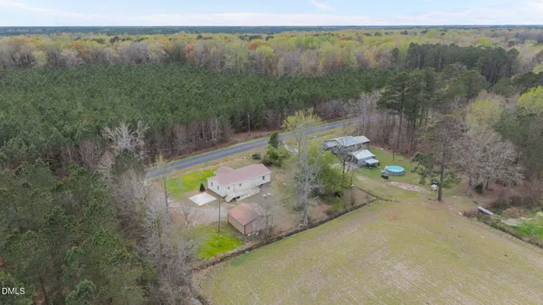 an aerial view of a house with a yard