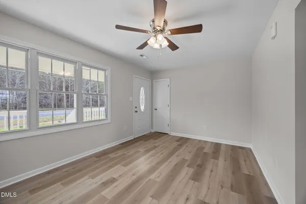 wooden floor in an empty room with a window