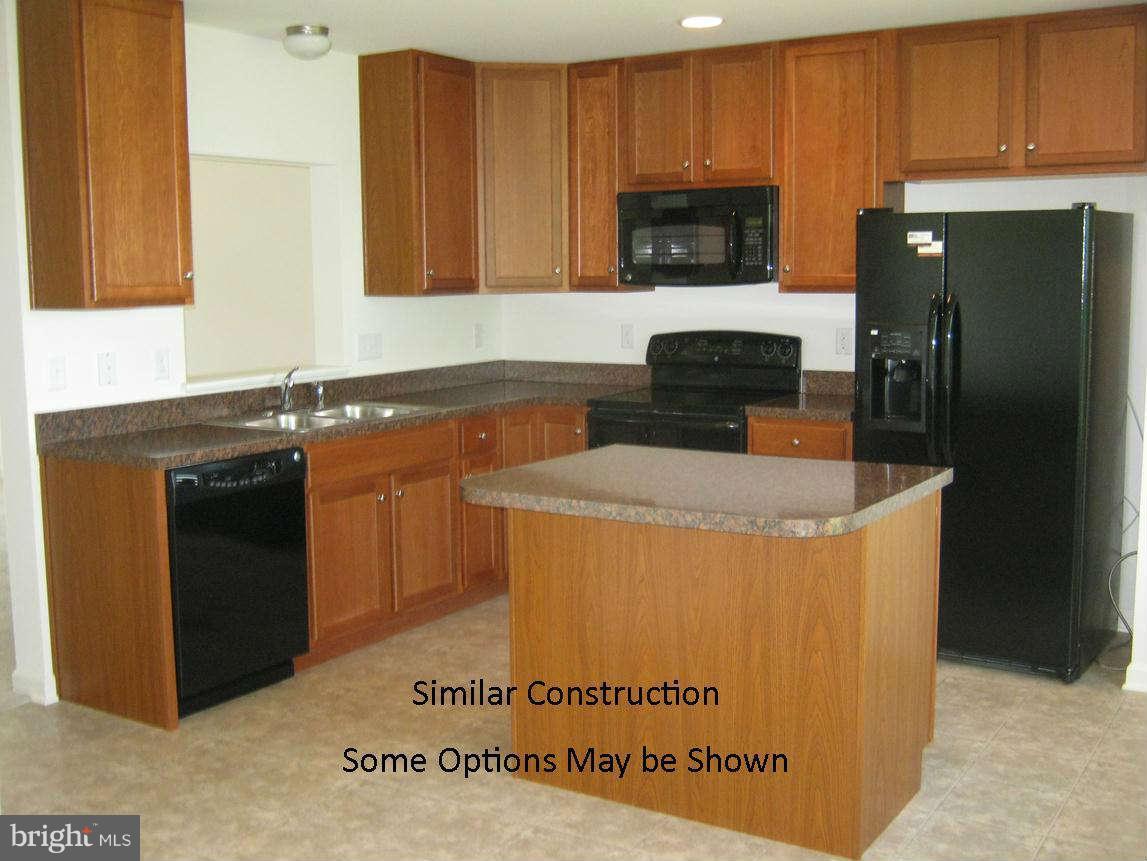 0 Stallion Street Ranson, WV 25438 - Photo 4 of 25 a kitchen with granite countertop a refrigerator stove and microwave