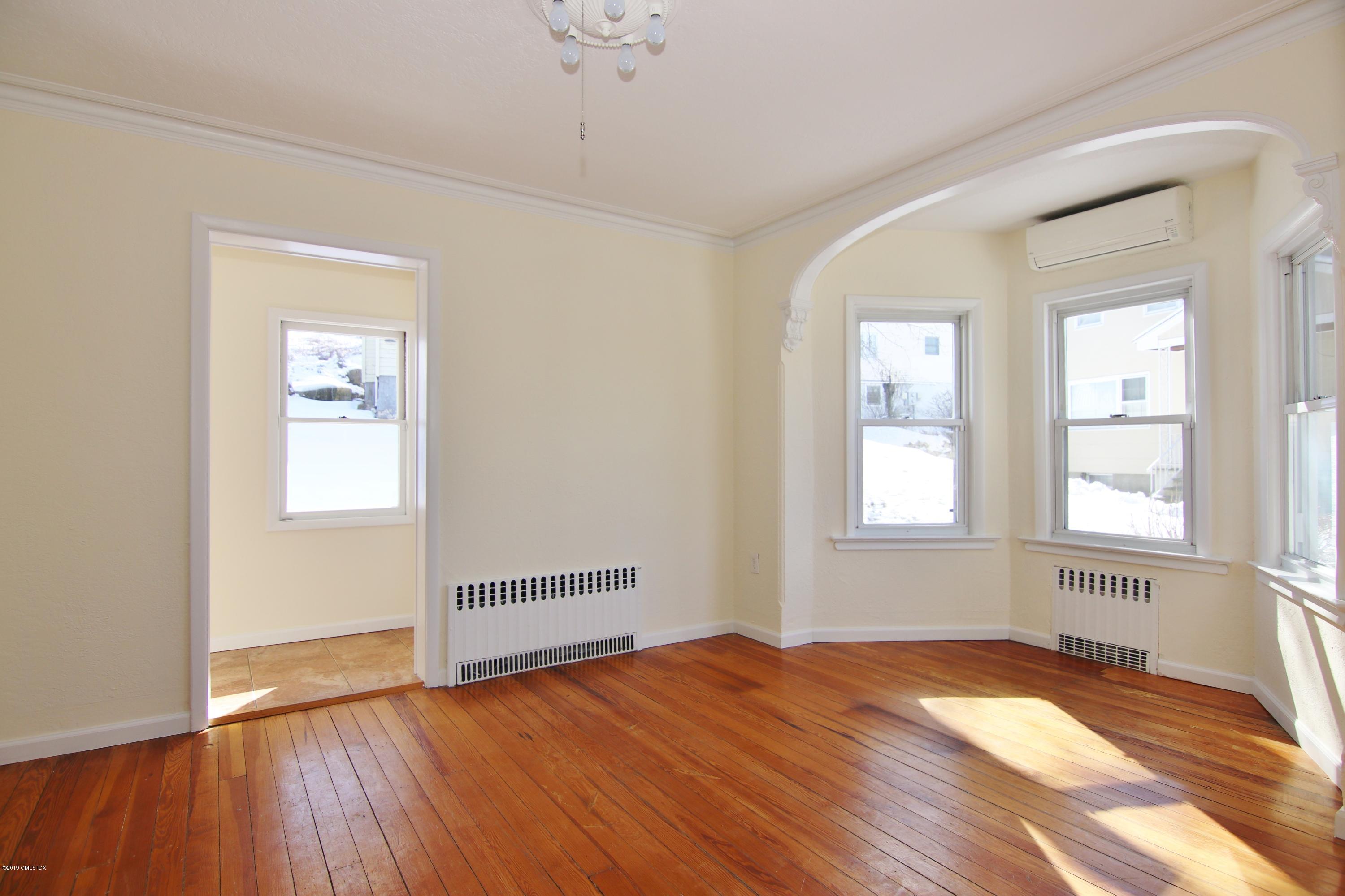 21 Byram Road Greenwich, CT 06830 - Photo 19 of 53 an empty room with wooden floor and windows