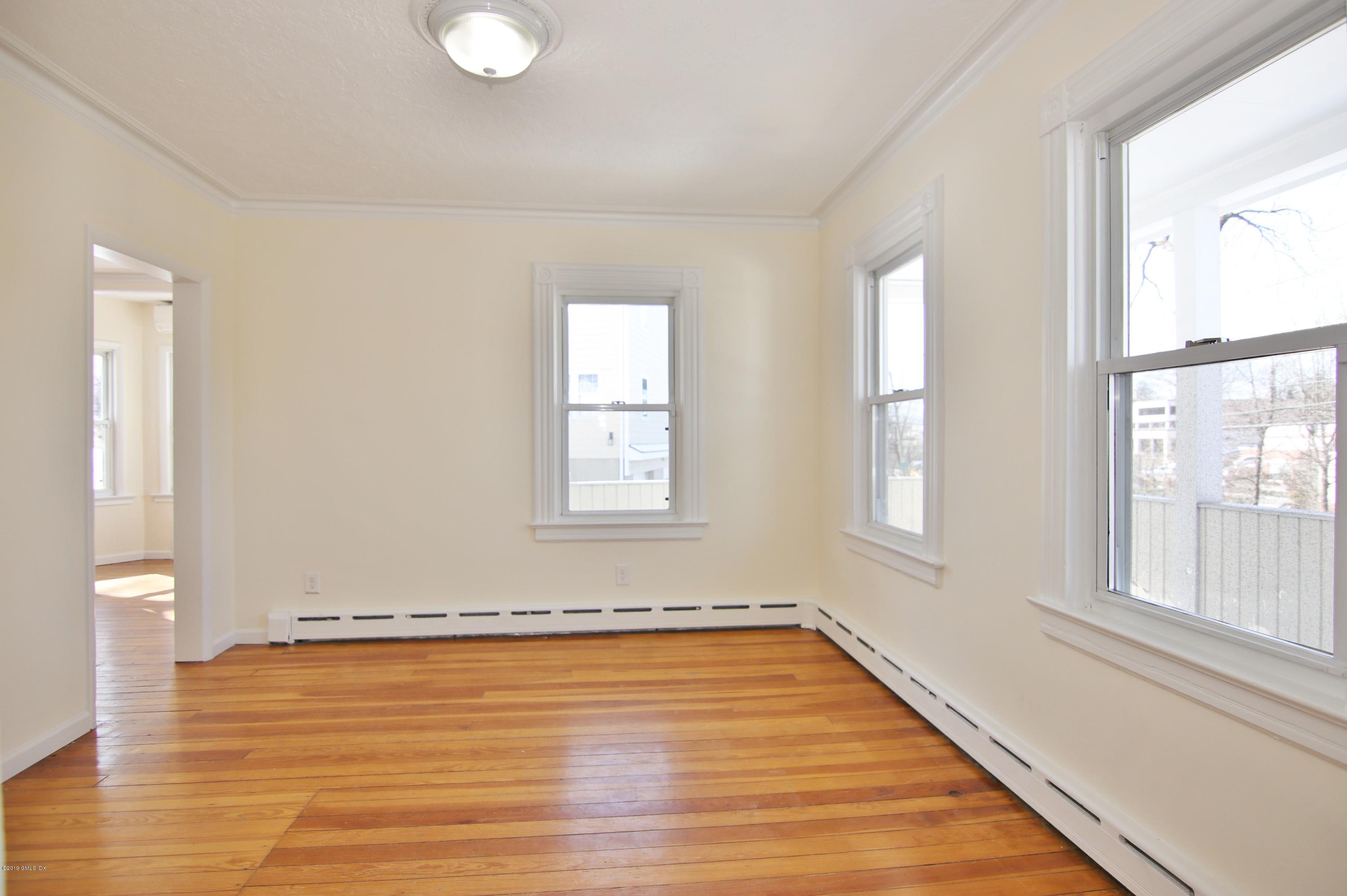 21 Byram Road Greenwich, CT 06830 - Photo 31 of 53 an empty room with wooden floor and windows