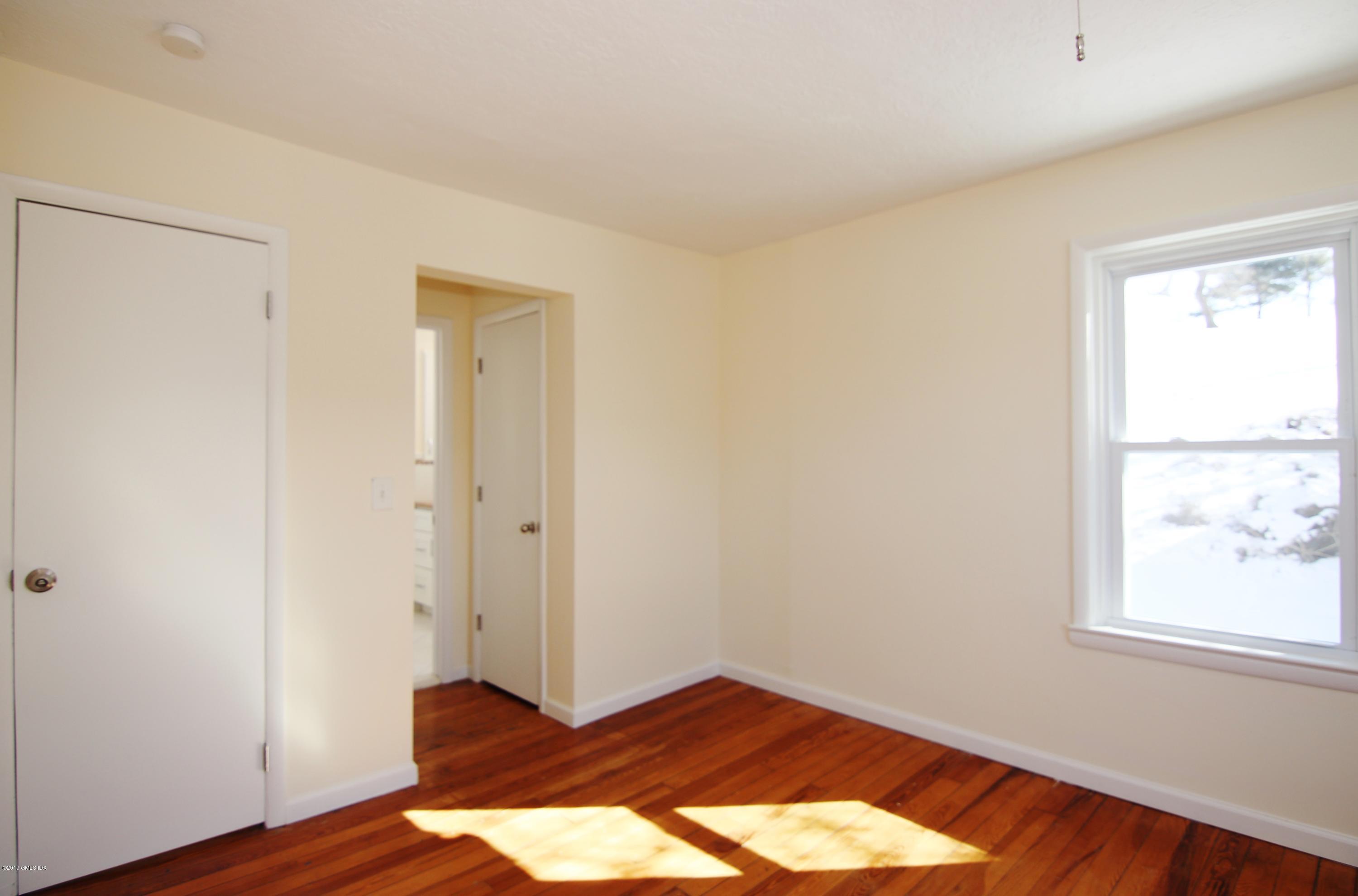 21 Byram Road Greenwich, CT 06830 - Photo 45 of 53 an empty room with wooden floor and windows