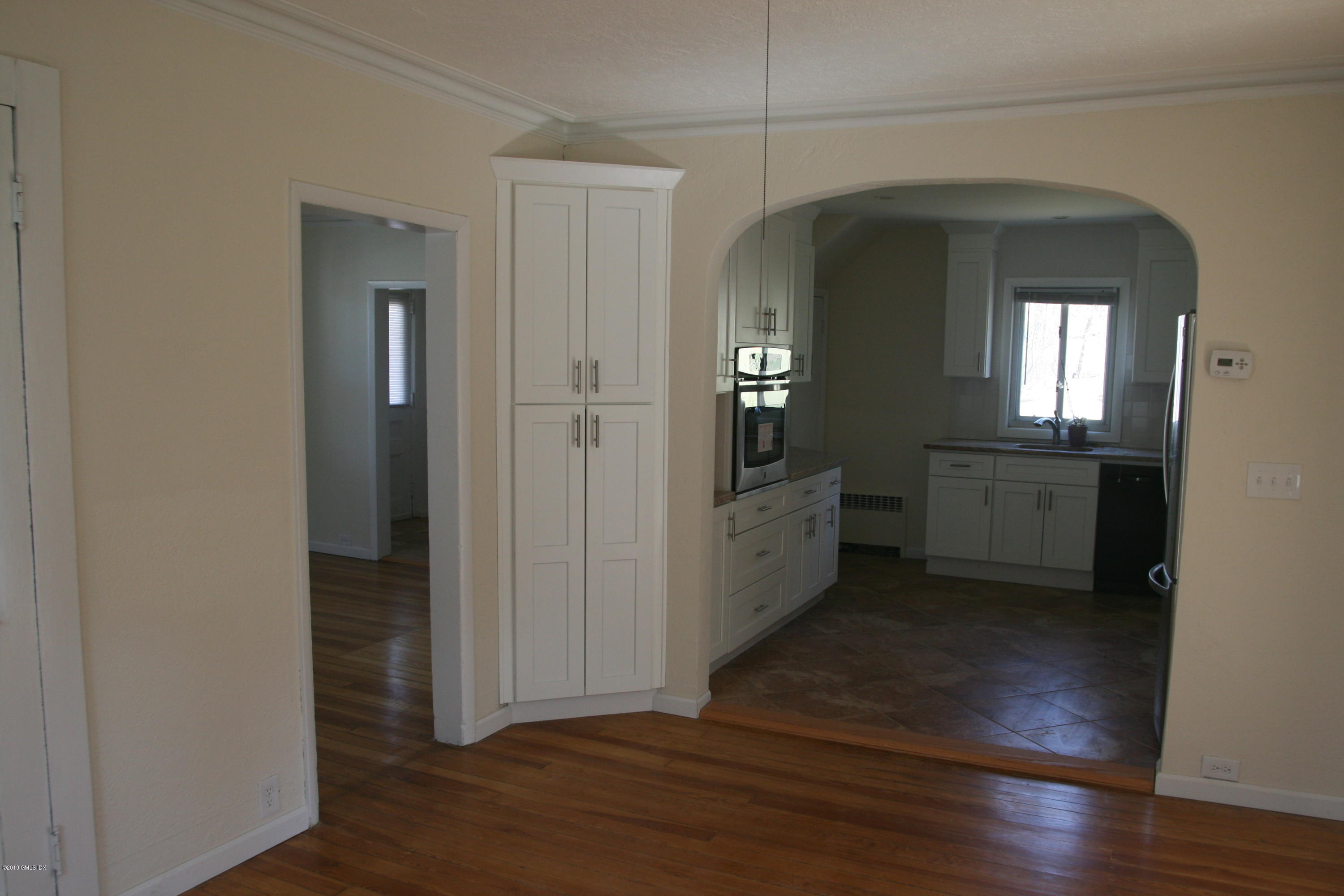 21 Byram Road Greenwich, CT 06830 - Photo 5 of 53 a view of a hallway with wooden floor and a living room