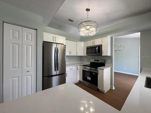 a kitchen with a refrigerator stove and microwave