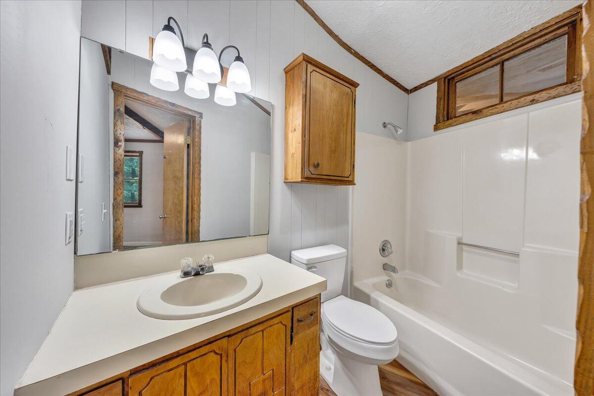 1902 Webbs Mill Road North Floyd, VA 24091 - Photo 12 of 30 a bathroom with a toilet a sink and a mirror