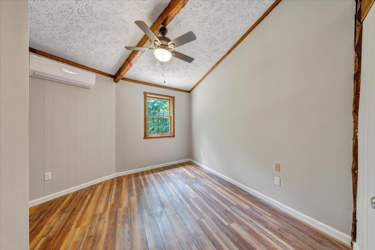 1902 Webbs Mill Road North Floyd, VA 24091 - Photo 14 of 30 an empty room with wooden floor fan and windows