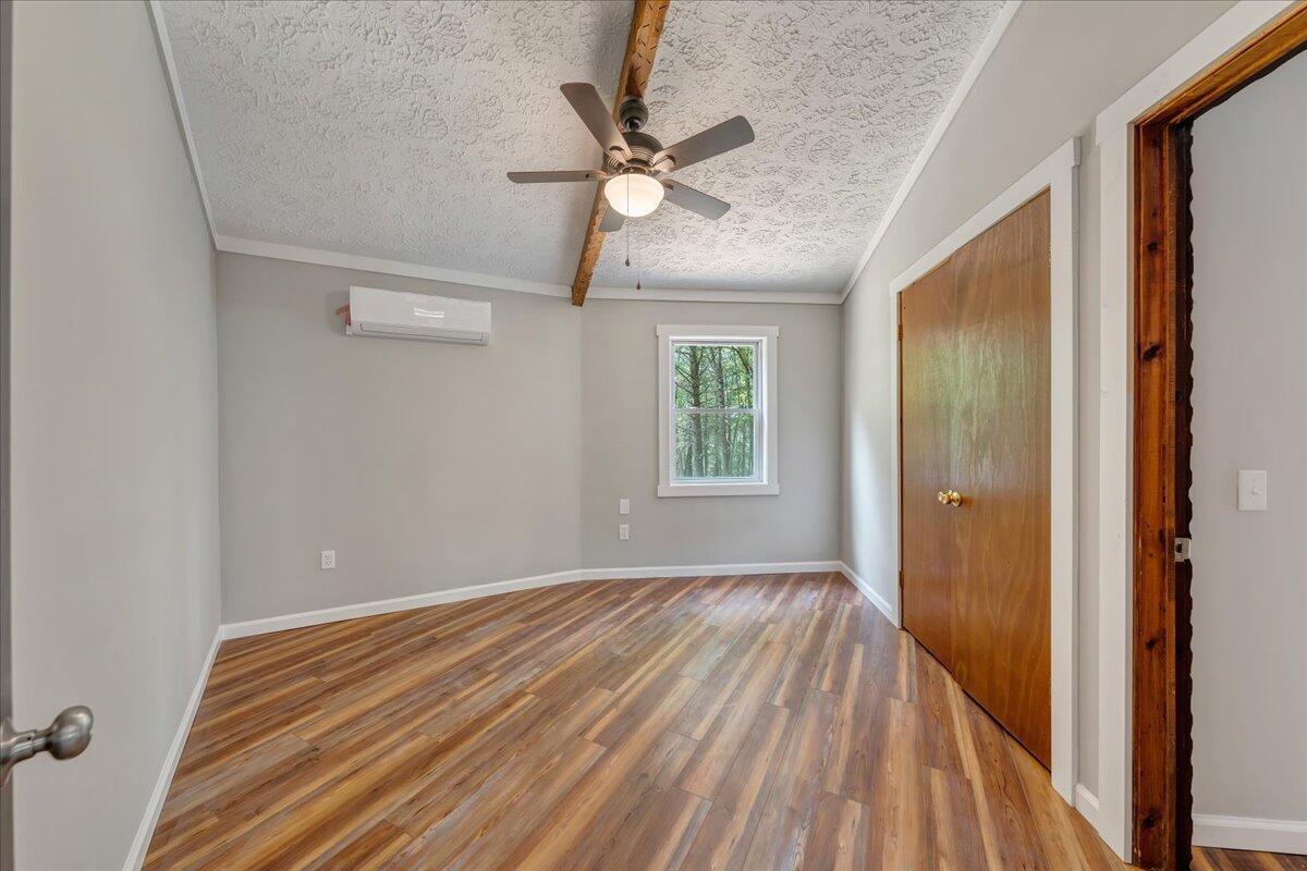 1902 Webbs Mill Road North Floyd, VA 24091 - Photo 19 of 30 a view of a room with a ceiling fan and wooden floor