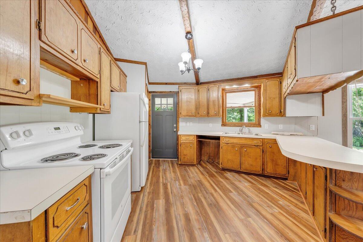 1902 Webbs Mill Road North Floyd, VA 24091 - Photo 26 of 30 a kitchen with stainless steel appliances kitchen island granite countertop a sink a counter space and cabinets