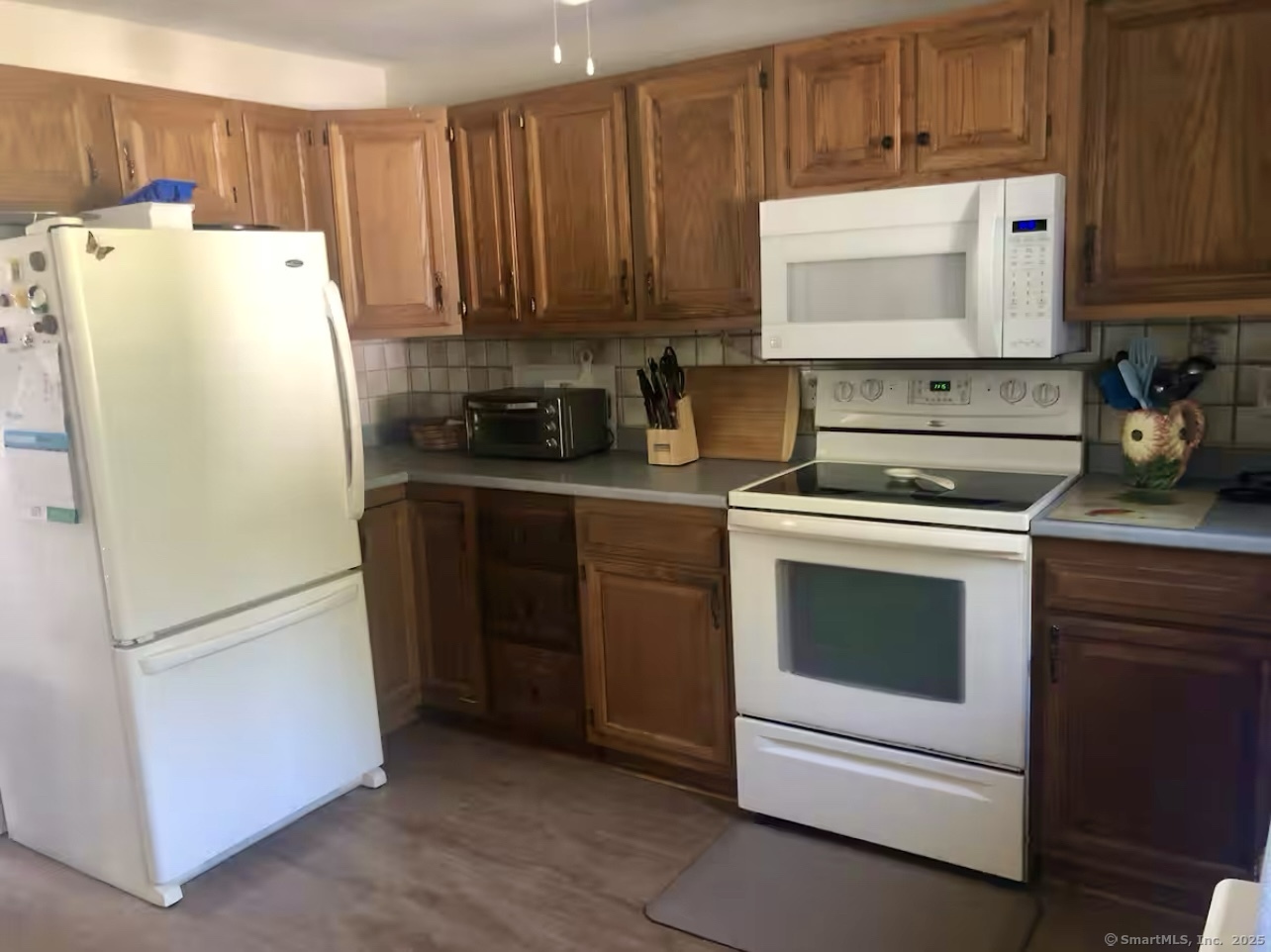 203 Pine Hollow Road Killingly, CT 06241 - Photo 5 of 33 a kitchen with refrigerator and cabinets