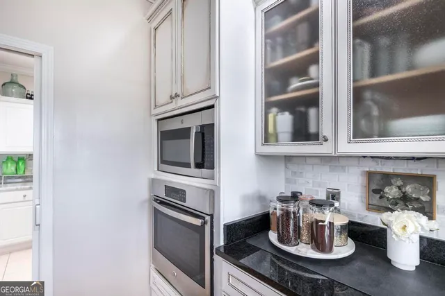 a kitchen with a sink stainless steel appliances and cabinets