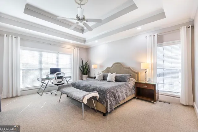 a bedroom with a bed and large window