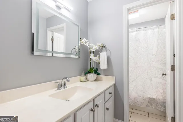 a bathroom with a sink vanity and a mirror
