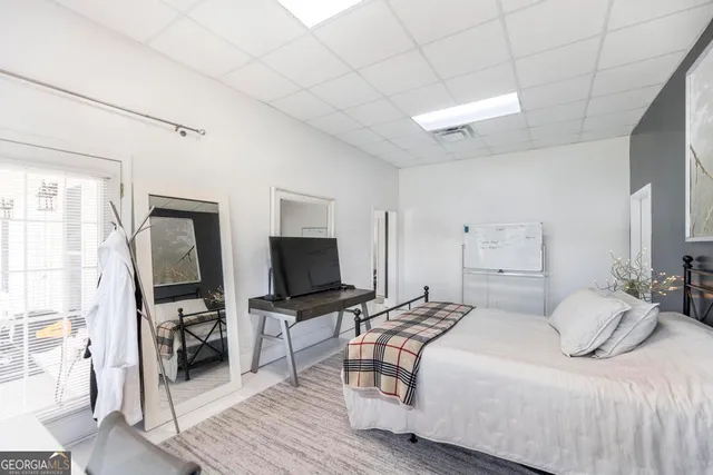 a bedroom with a bed and a flat screen tv