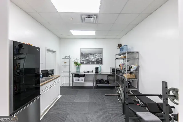 a kitchen with sink refrigerator and cabinets
