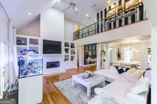 a living room with fireplace furniture and a flat screen tv