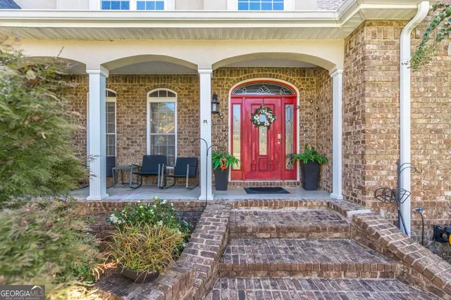 a front view of a house with garden