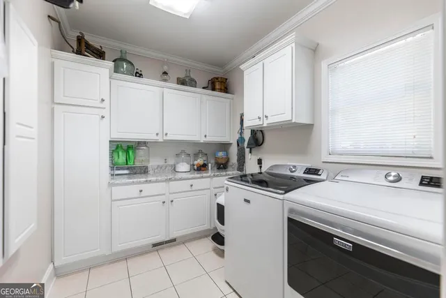 a kitchen with stainless steel appliances granite countertop a sink stove and white cabinets