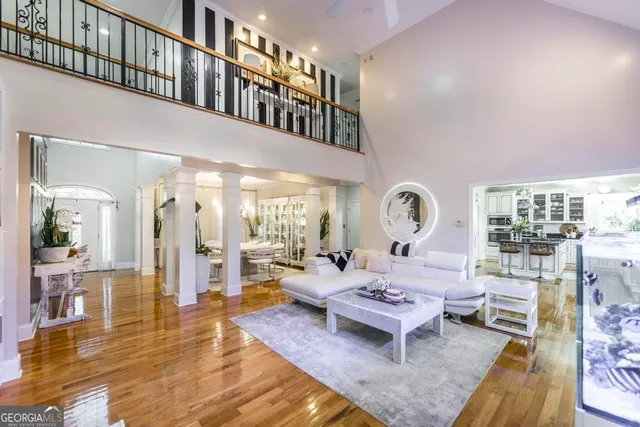a living room with furniture a rug and a chandelier