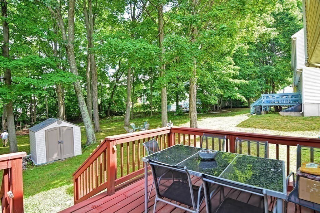 a view of a wooden deck and a backyard