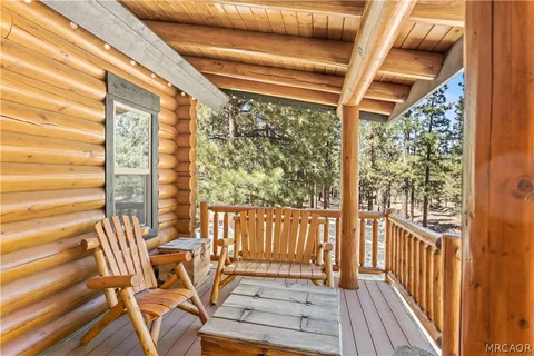 a view of porch with a table and chairs