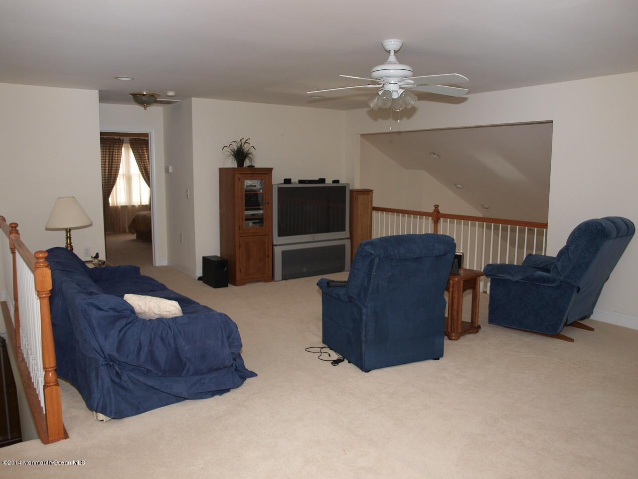 80 Pancoast Road Waretown, NJ 08758 - Photo 29 of 32 a living room with furniture and a chandelier