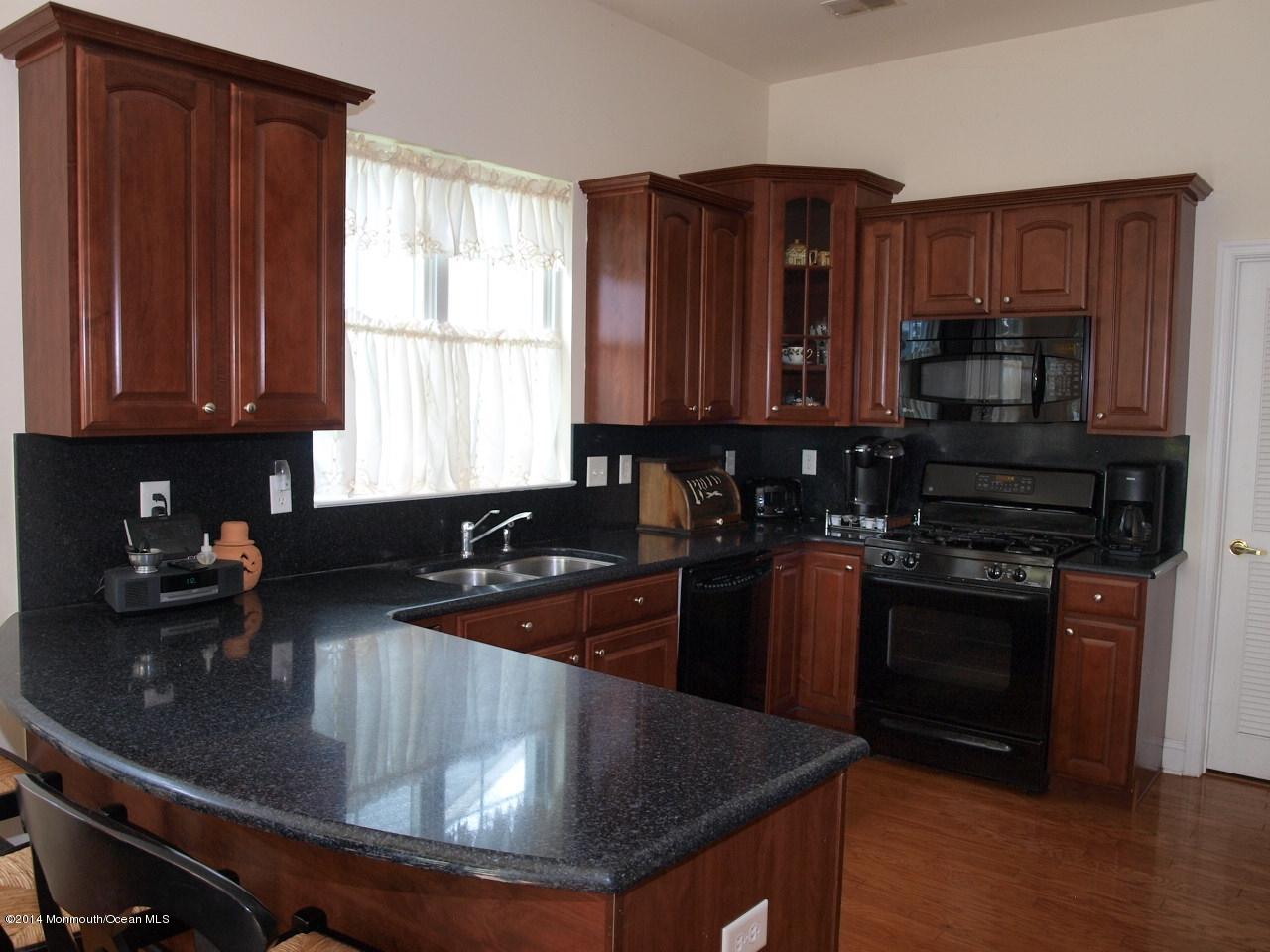 80 Pancoast Road Waretown, NJ 08758 - Photo 5 of 32 a kitchen with stainless steel appliances granite countertop a sink stove and microwave