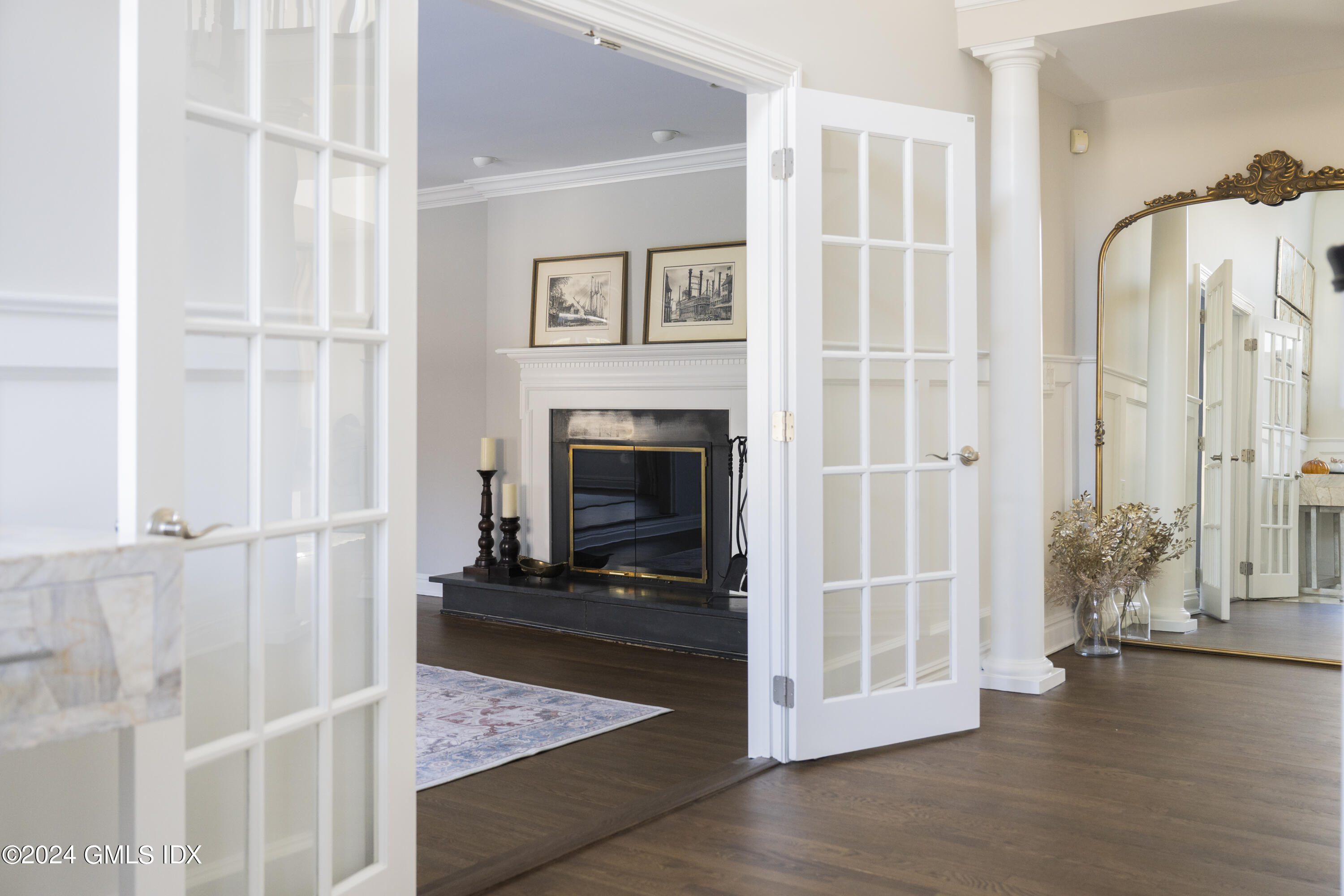 17 Rustic View Road Greenwich, CT 06830 - Photo 12 of 26 a view of a livingroom with wooden floor and a fireplace
