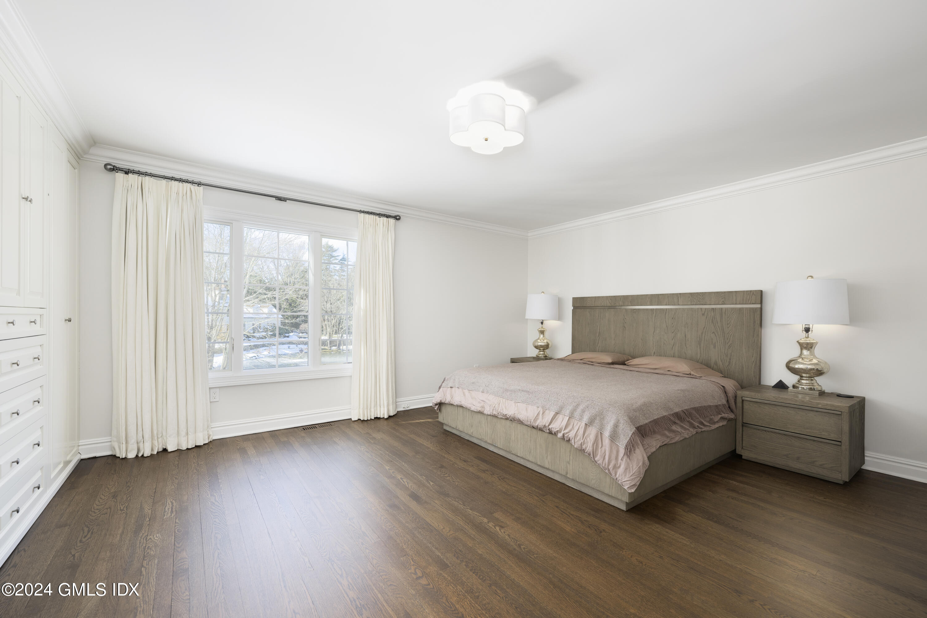 17 Rustic View Road Greenwich, CT 06830 - Photo 13 of 26 a bedroom with a bed and a large window